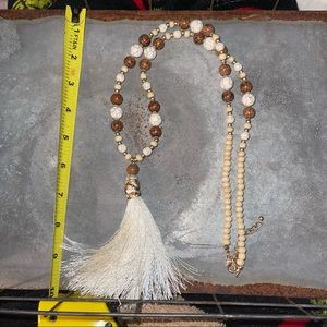 Gold, cream and brown beaded necklace with tassel.